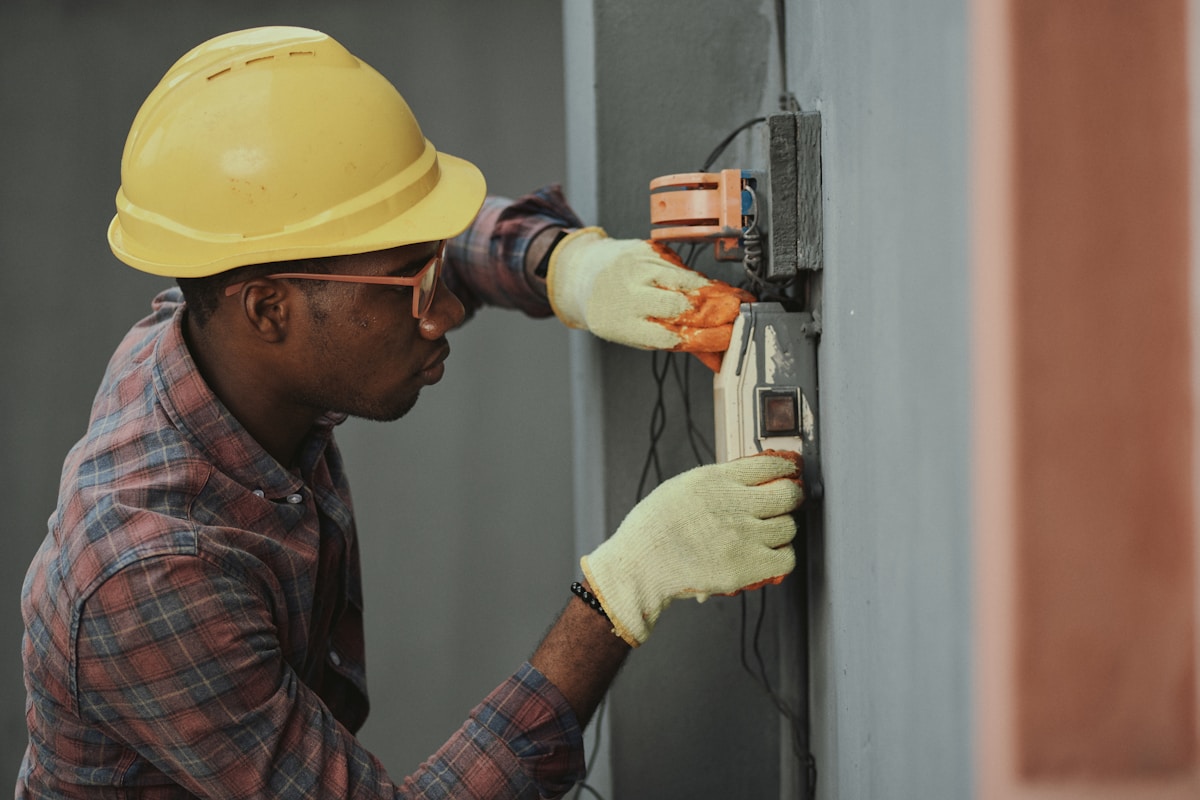 Electrician working on electrical panel wiring