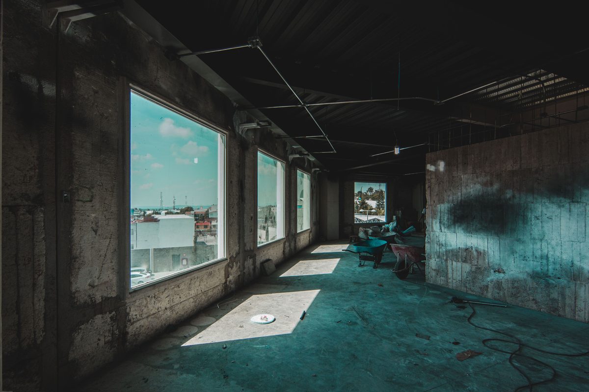 Empty commercial unit stripped out with wheelbarrows on site